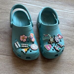 Aqua Blue Crocs full of charms women’s size 6